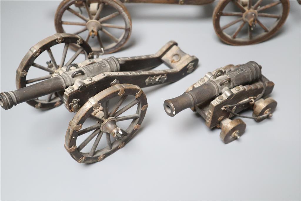 Three oak and wrought iron models of historic cannons, longest 39cm